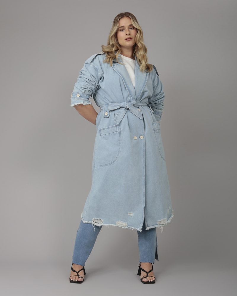 Front of a model wearing a size XL Women's AVERY-BO Denim Trenchcoat in Blue Opal by LOLA JEANS. | dia_product_style_image_id:321873